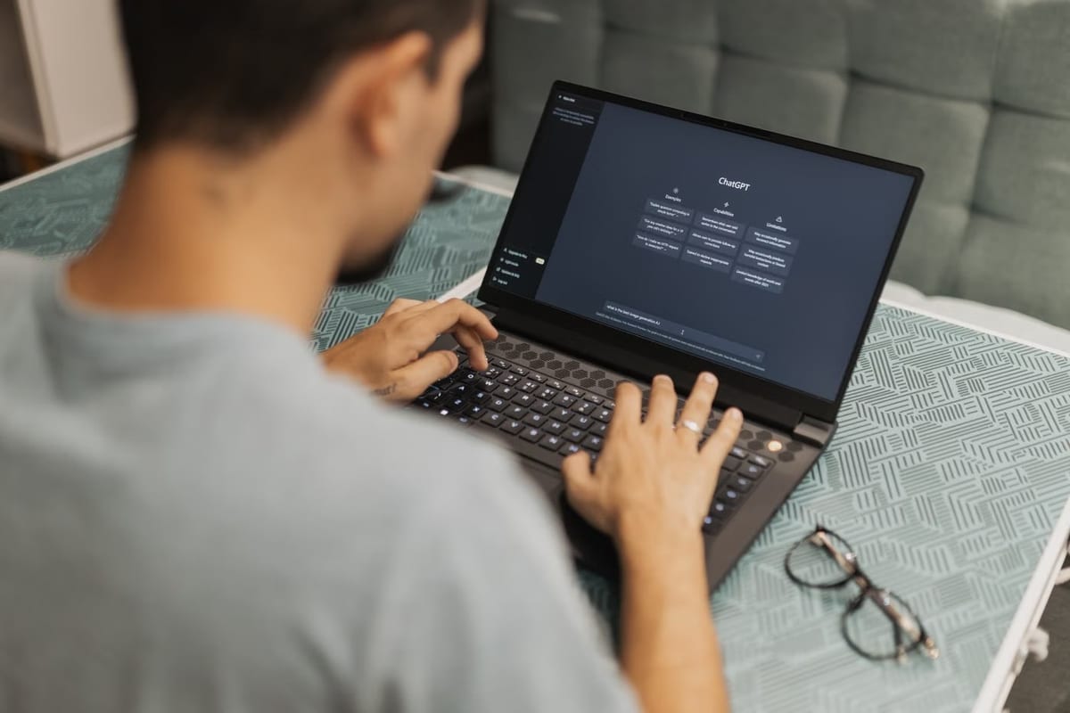 Homem digitando em um notebook com o ChatGPT aberto na tela